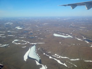 The view from the plane as we get closer to Kugluktuk. These lakes are still covered in ice while the lakes to the south have already thawed for the season. (Photo credit: John Kelly)