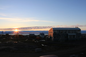 The view of the sunset from Enokhuk Inn. The clouds on the horizon present the closest thing to the actual horizon during the summer months where the sun never completely sets in the Arctic. (Photo credit: John Kelly)