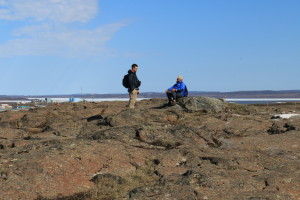 Researchers Greg Lehn and Rob Macdonald discuss the interesting geology of the region. The rock beneath them is metamorphic, but below that layer is a layer of sedimentary rock - a form of shale. This rare event is caused when rock that has been melted from heat and pressure below gets pushed through a gap in sedimentary rock to the surface where it flattens out. (Photo credit: John Kelly)