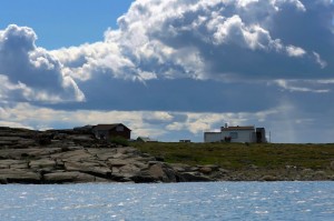 A few small homes on one of the islands in the middle of the Coppermine River estuary. (Photo credit: Robie Macdonald)